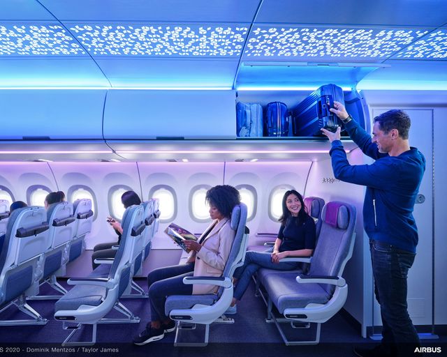 Passenger loading luggage in XL bin and ambient lighting in A320 Airspace Cabin Passenger loading luggage in XL bin and ambient lighting in A320 Airspace Cabin